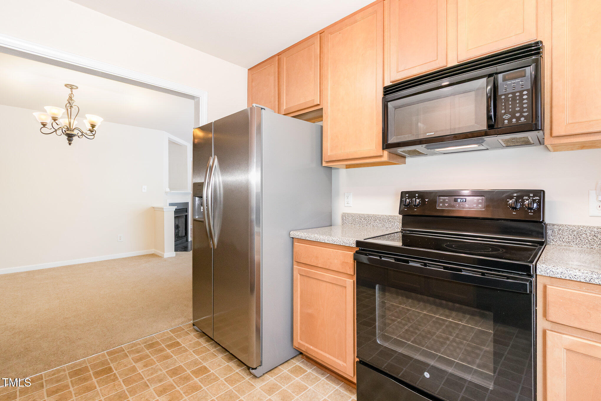 2126 Kedvale Avenue Raleigh, NC 27617 - Photo 9 of 18 a kitchen with stainless steel appliances granite countertop a stove microwave and refrigerator