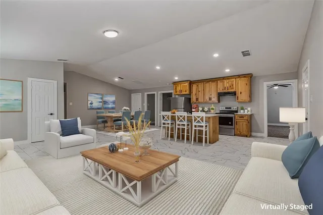 a living room with furniture a kitchen view and a kitchen