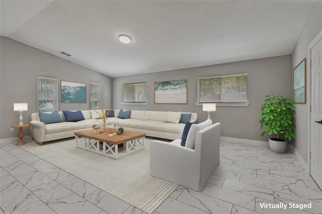 a living room with furniture potted plant and a window