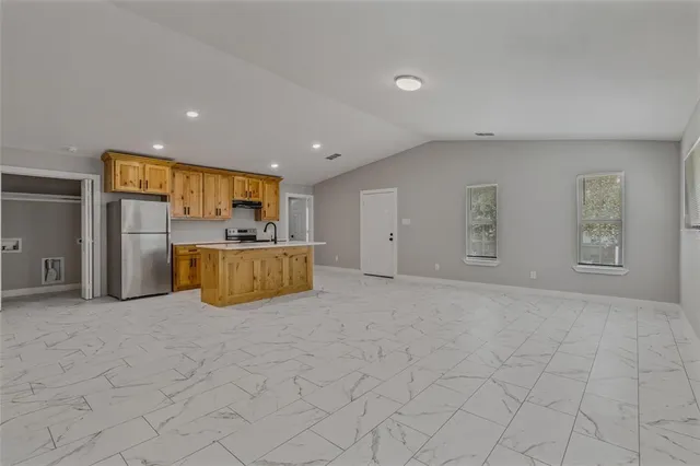 a bedroom with a bed and a large mirror