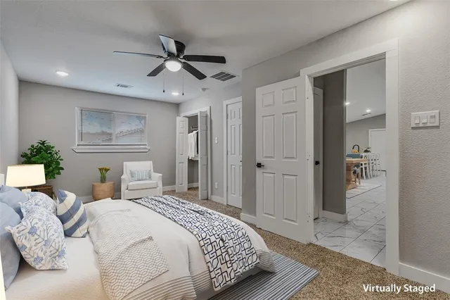 a view of an empty room and a ceiling fan