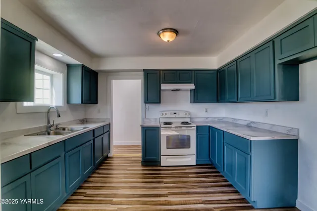 a kitchen with stainless steel appliances granite countertop a sink stove and cabinets