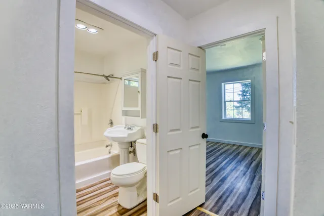 a bathroom with a toilet sink and a mirror