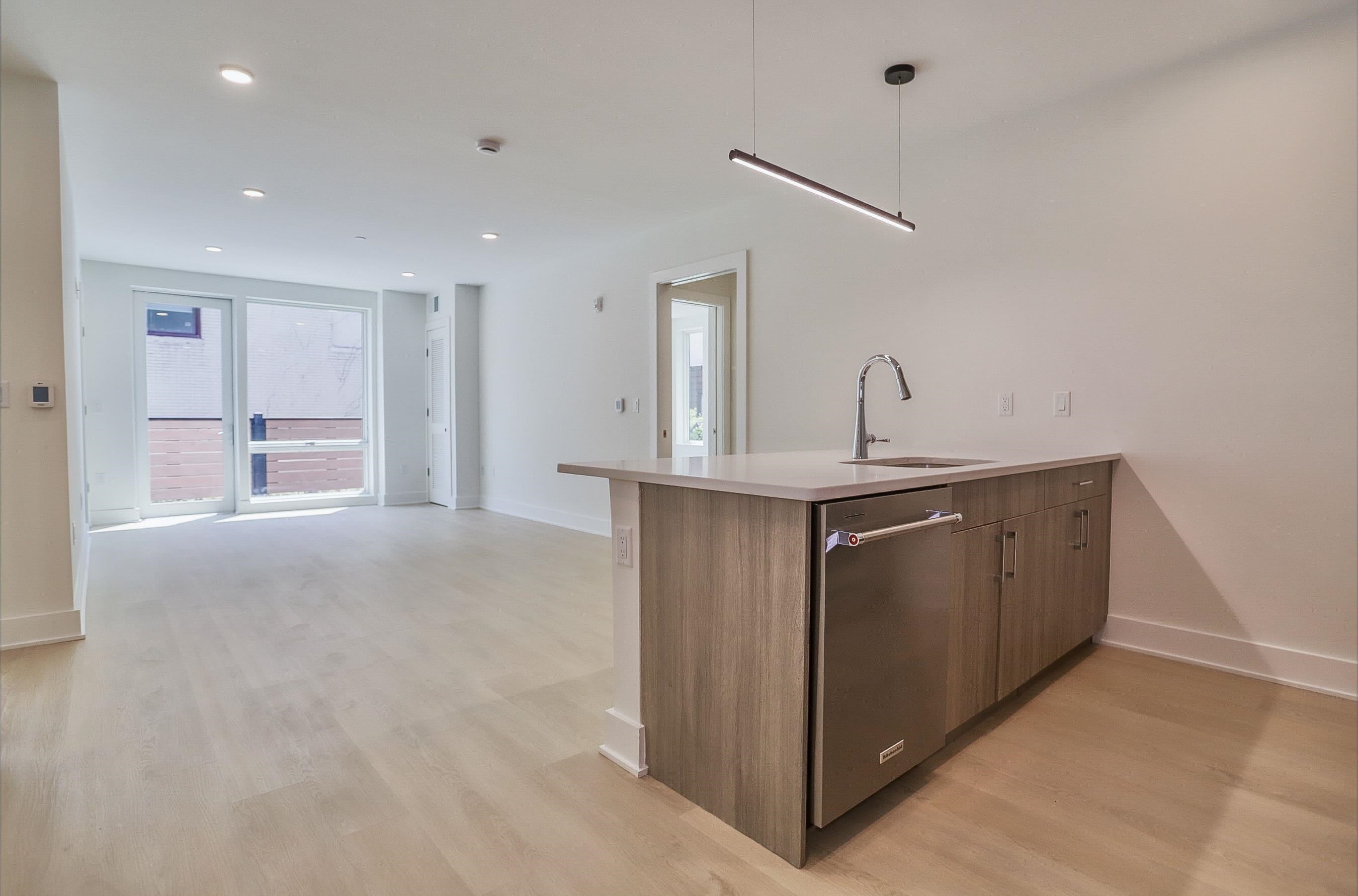 303 Madison Street, Unit 306 Hoboken, NJ 07030 - Photo 2 of 24 a kitchen with kitchen island sink and refrigerator