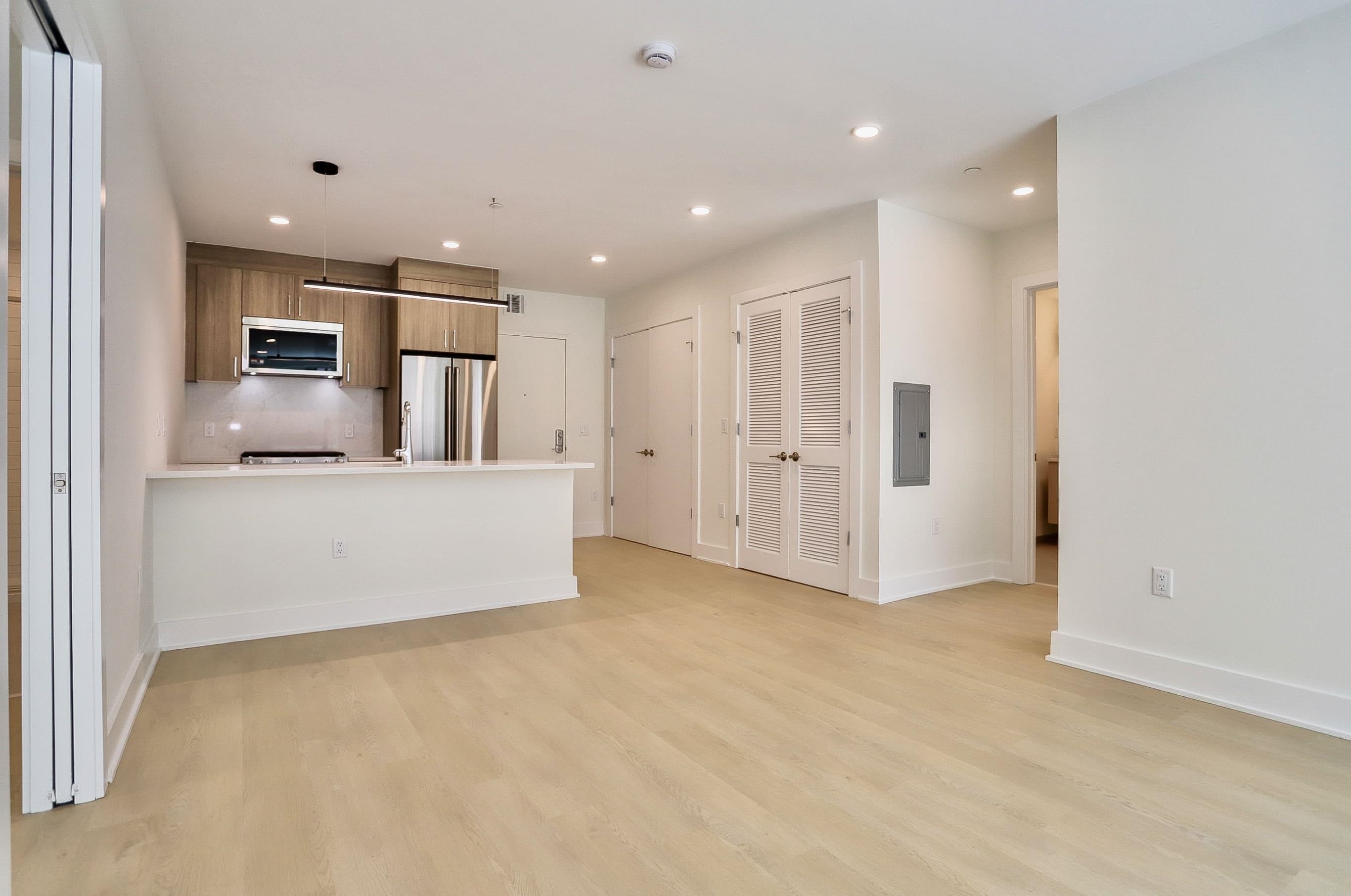 303 Madison Street, Unit 306 Hoboken, NJ 07030 - Photo 5 of 24 a view of a kitchen with refrigerator and a sink