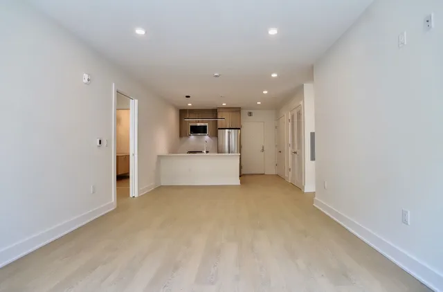 a view of a kitchen with white cabinets