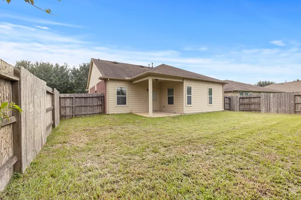 a view of a house with a backyard