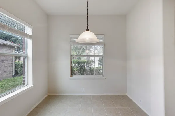 a room with a window and a chandelier