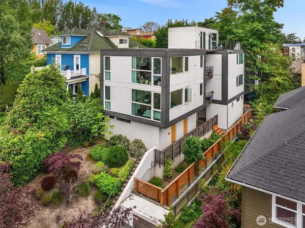 an aerial view of a house with a yard and potted plants