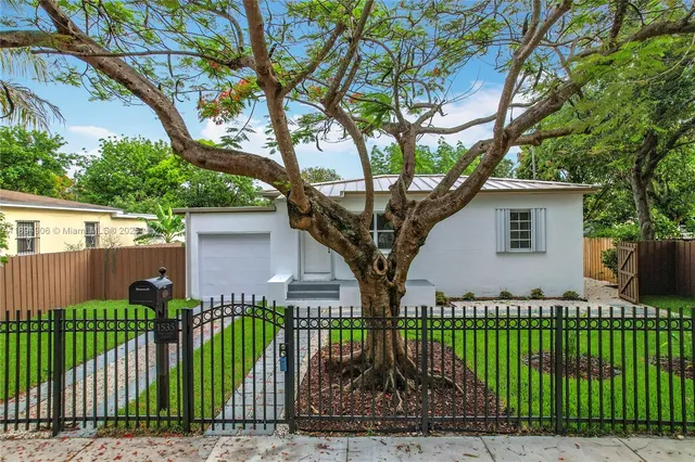 a front view of a house with a garden