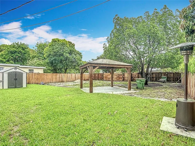 a view of house with backyard space and garden