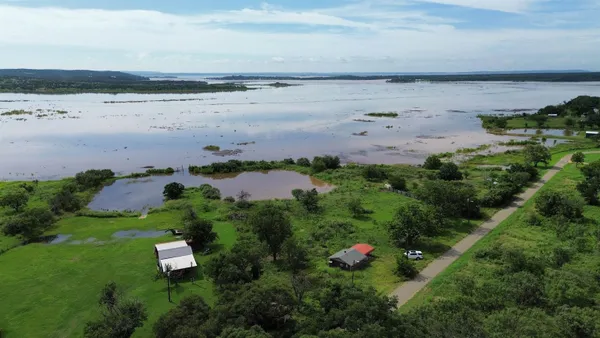 an aerial view of a city with lots of residential buildings and lake view