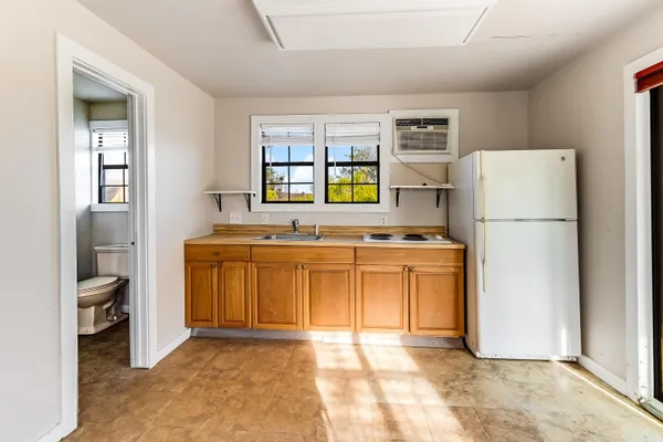 a kitchen with a refrigerator and a sink