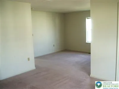 a view of an empty room and a window