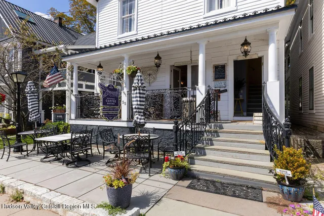 a front view of a building with outdoor seating