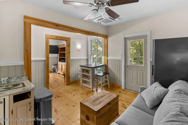 a bedroom with a bed tv and window