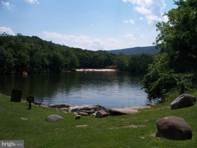 39 Montevideo Road Berkeley Springs, WV 25411 - Photo 3 of 8 a view of a lake with a yard