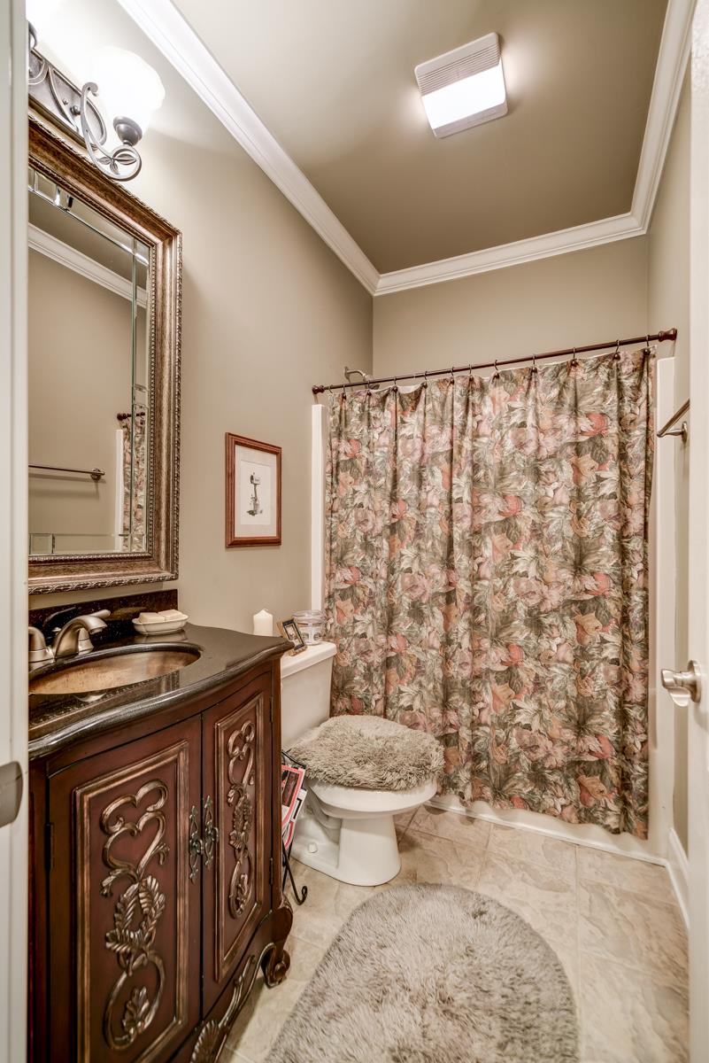 3338 Allen Barrett Road Murfreesboro, TN 37129 - Photo 16 of 27 a bathroom with a granite countertop sink a toilet a mirror and shower curtain
