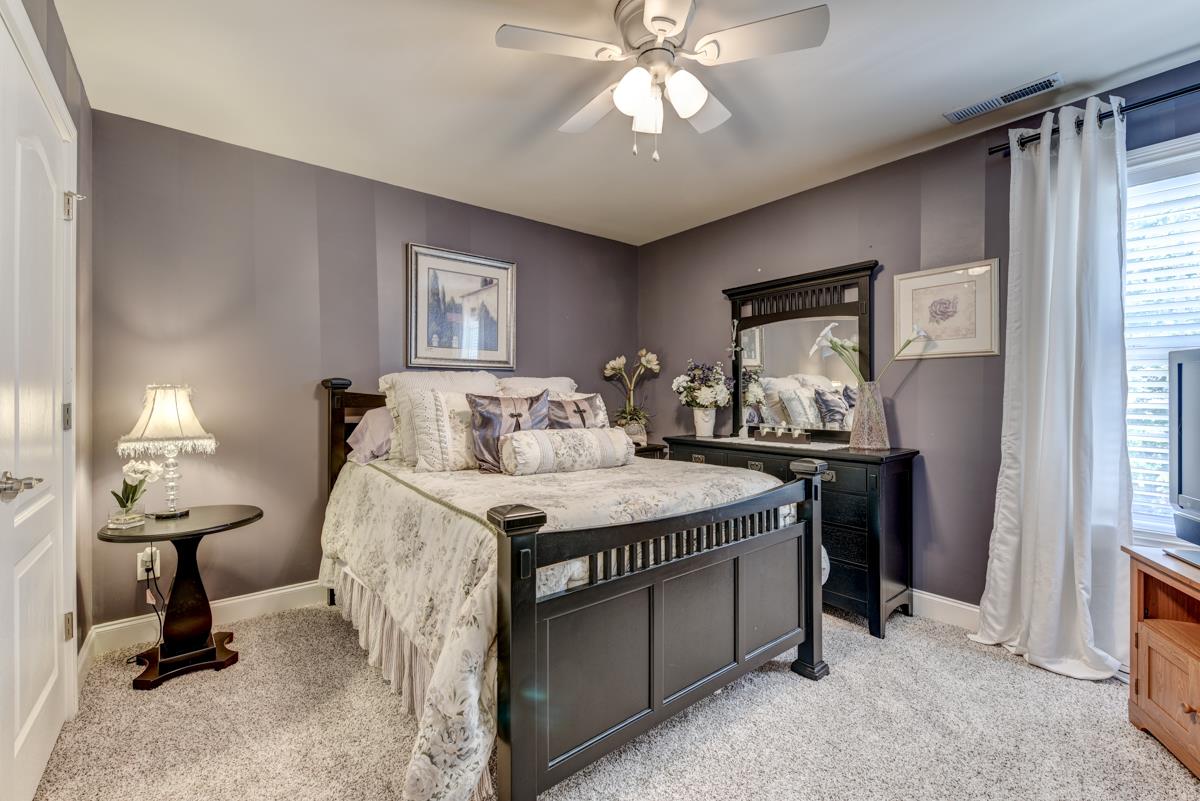 3338 Allen Barrett Road Murfreesboro, TN 37129 - Photo 19 of 27 a bedroom with a bed and a chandelier