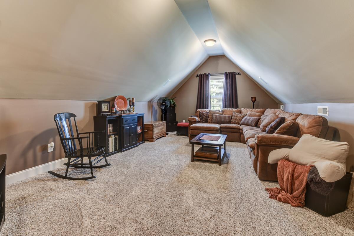 3338 Allen Barrett Road Murfreesboro, TN 37129 - Photo 21 of 27 a living room with furniture and a book shelf