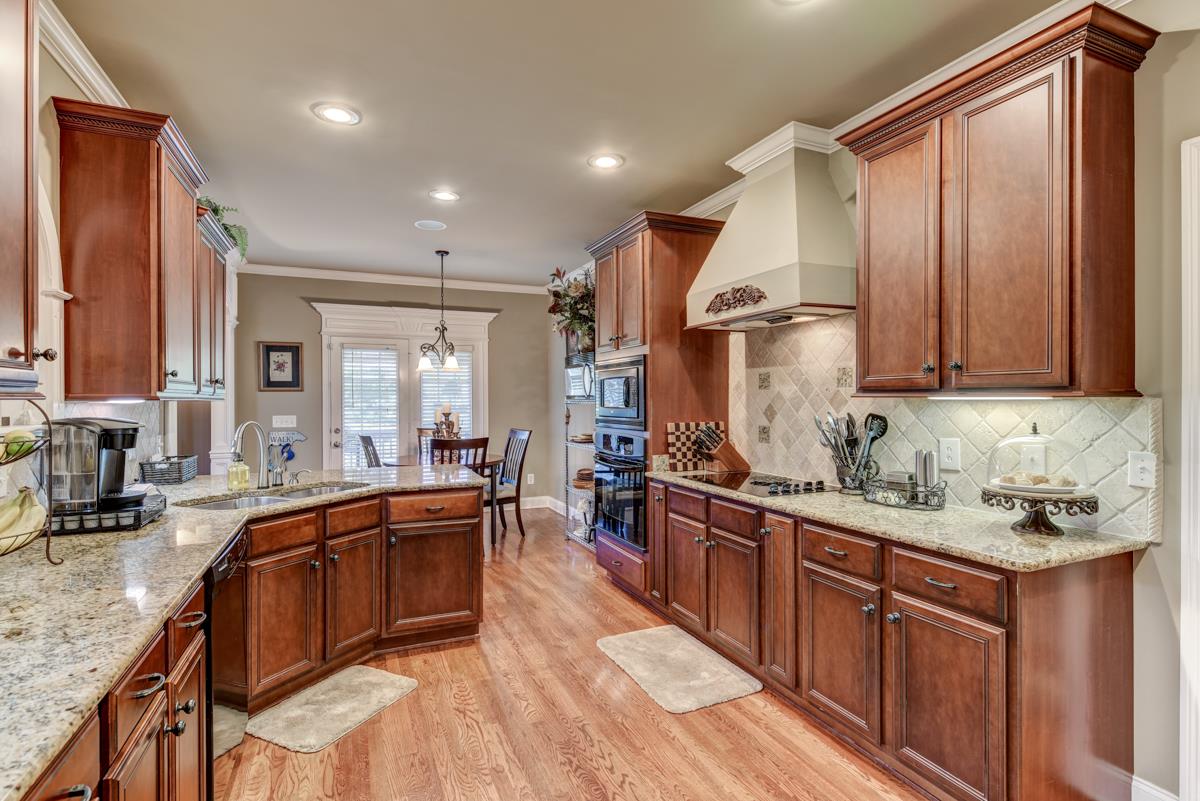 3338 Allen Barrett Road Murfreesboro, TN 37129 - Photo 6 of 27 a kitchen with stainless steel appliances granite countertop a sink stove and cabinets