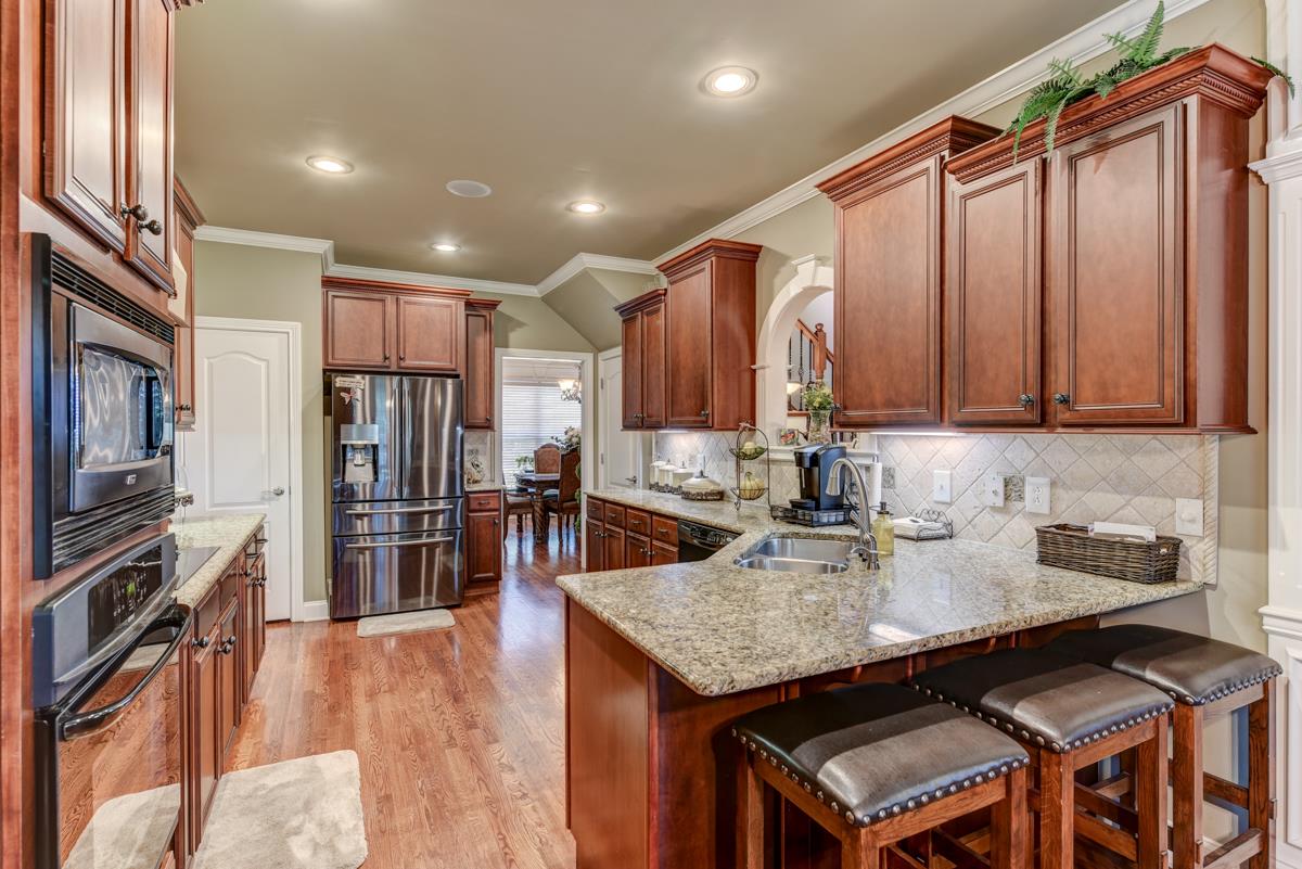 3338 Allen Barrett Road Murfreesboro, TN 37129 - Photo 7 of 27 a kitchen with stainless steel appliances granite countertop a sink a stove and a refrigerator