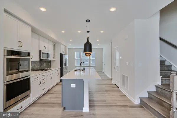 a large kitchen with stainless steel appliances