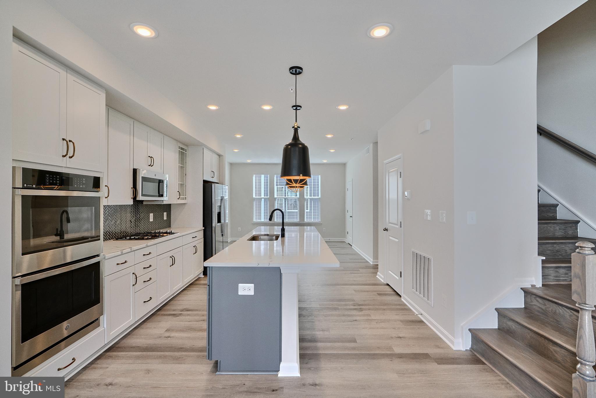 2509 Gatwick Lane, Unit 60 Frederick, MD 21701 - Photo 13 of 30 a large kitchen with stainless steel appliances