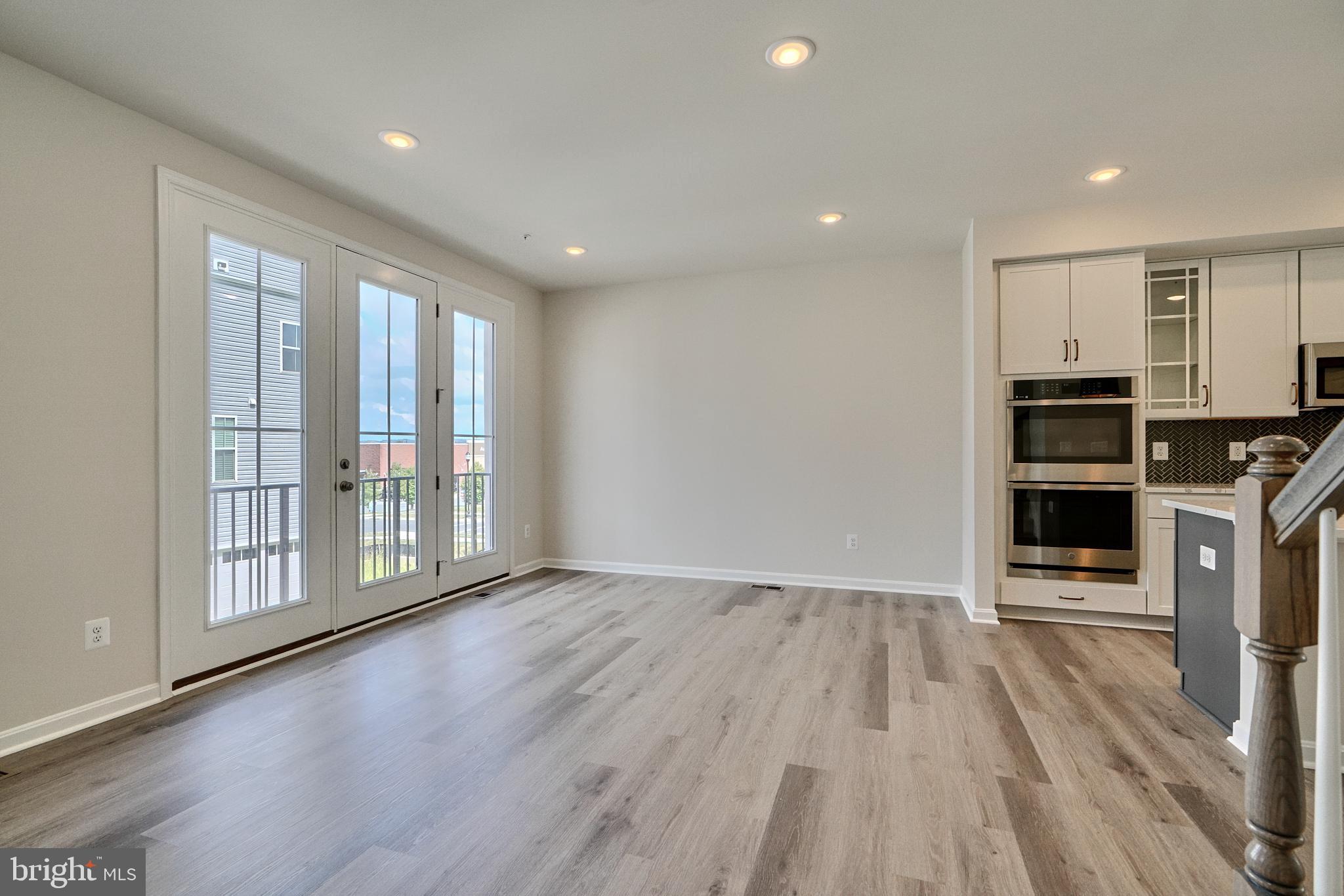 2509 Gatwick Lane, Unit 60 Frederick, MD 21701 - Photo 14 of 30 a view of wooden floor and windows in a room