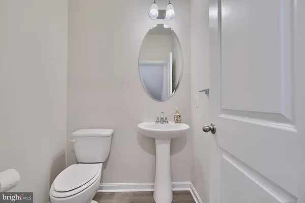 a bathroom with a toilet a sink and mirror