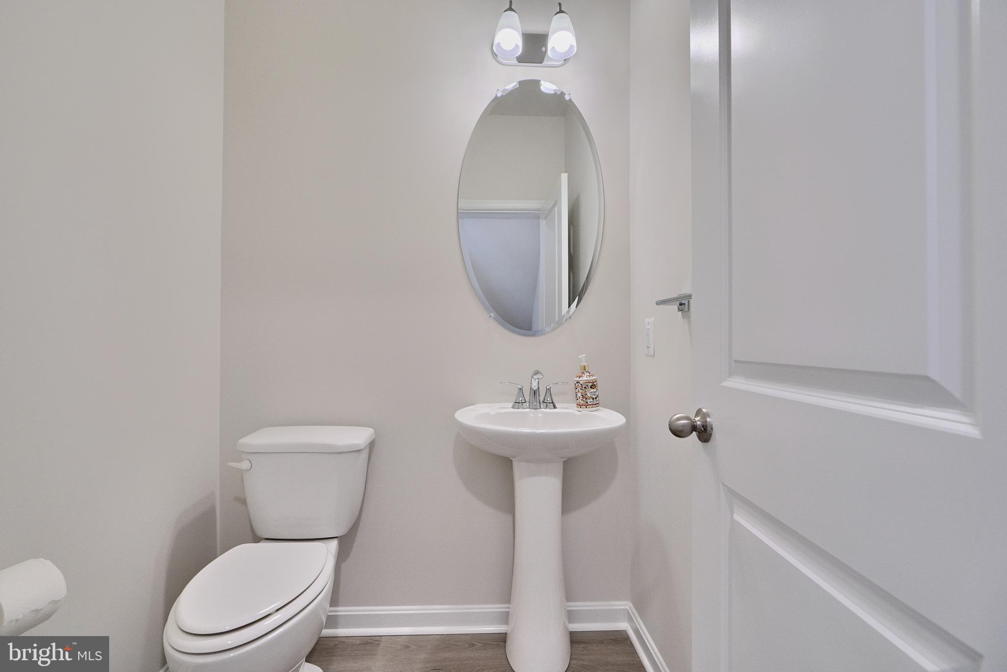 2509 Gatwick Lane, Unit 60 Frederick, MD 21701 - Photo 16 of 30 a bathroom with a toilet a sink and mirror