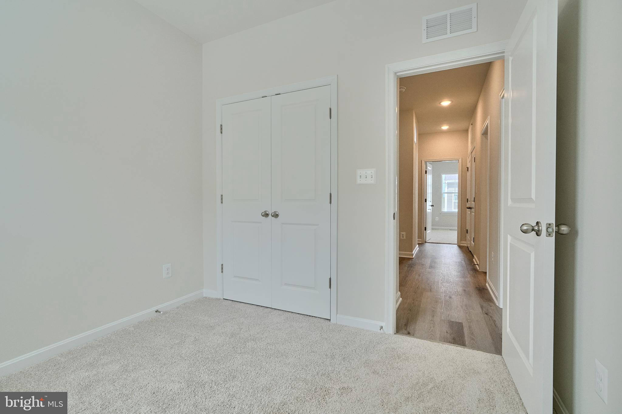 2509 Gatwick Lane, Unit 60 Frederick, MD 21701 - Photo 19 of 30 a view of a hallway with wooden floor