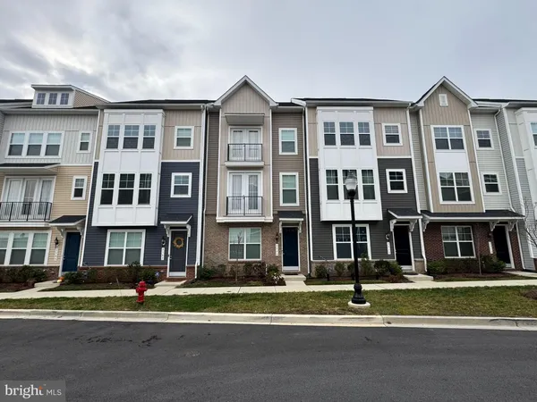 a view of a brick building next to a yard