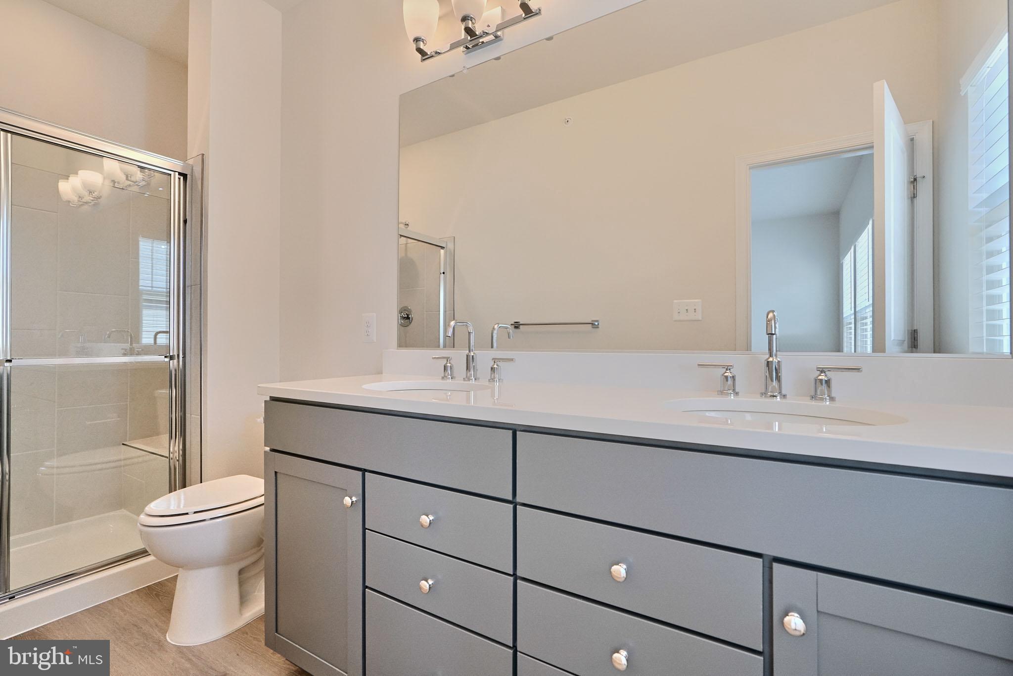 2509 Gatwick Lane, Unit 60 Frederick, MD 21701 - Photo 26 of 30 a bathroom with a toilet sink and mirror