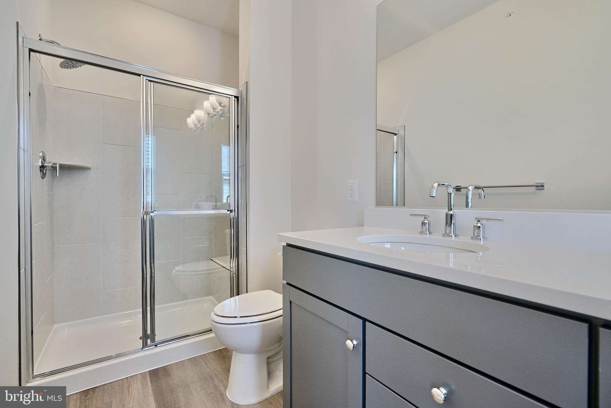 2509 Gatwick Lane, Unit 60 Frederick, MD 21701 - Photo 27 of 30 a bathroom with a granite countertop sink toilet and shower