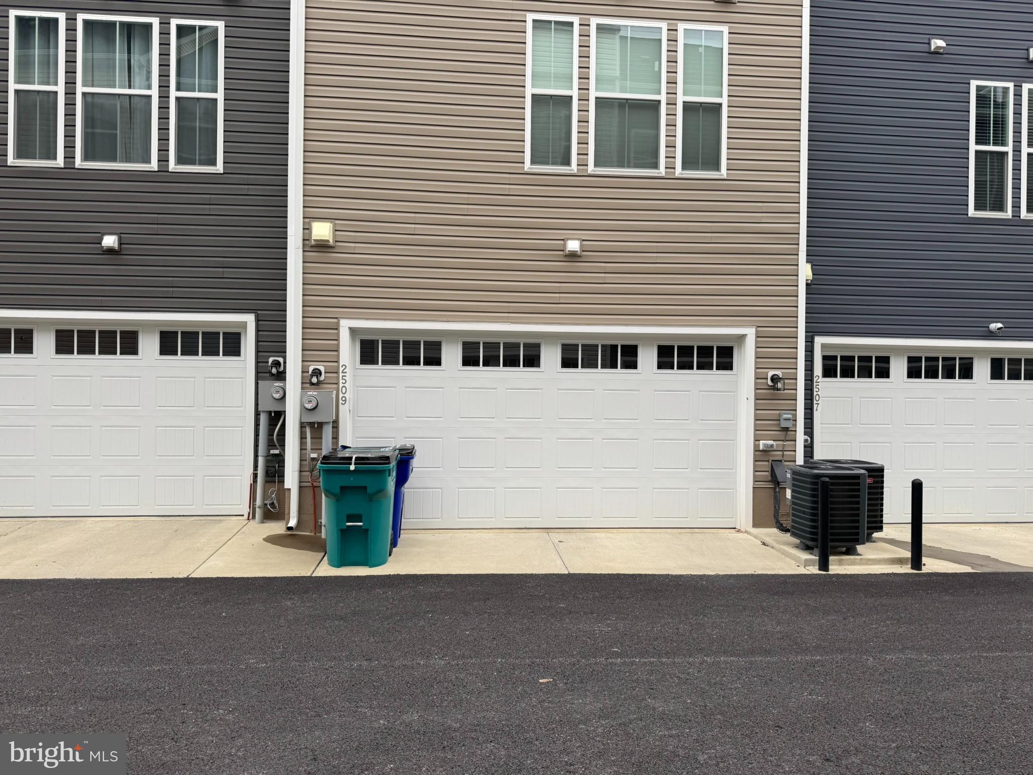 2509 Gatwick Lane, Unit 60 Frederick, MD 21701 - Photo 4 of 30 a front view of a house with a yard and garage