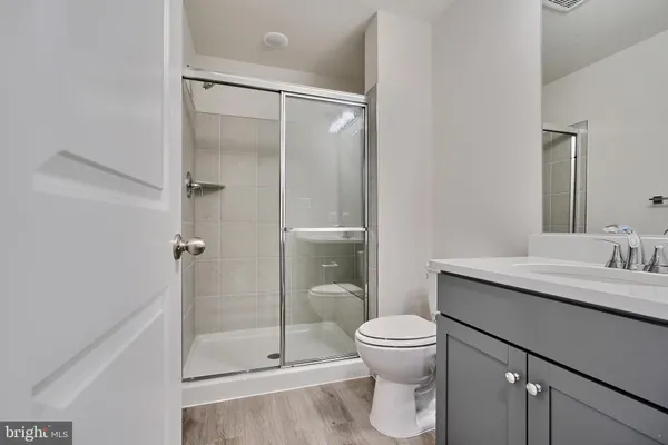 a bathroom with a toilet a sink and shower