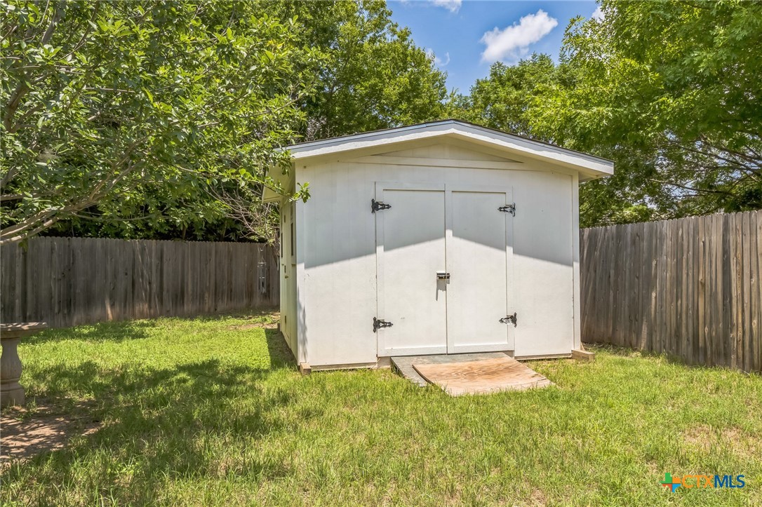 101 Cannery Cove Leander, TX 78641 - Photo 30 of 40 a view of backyard with small cabin and wooden fence
