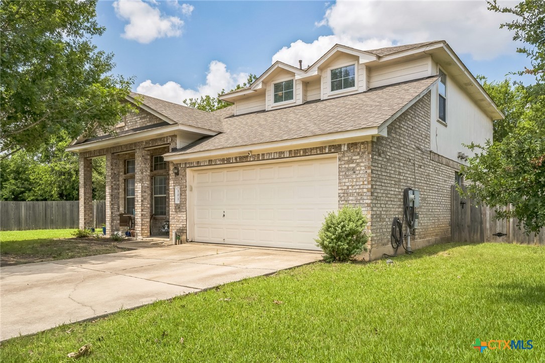 101 Cannery Cove Leander, TX 78641 - Photo 3 of 40 a front view of a house with a garden and plants