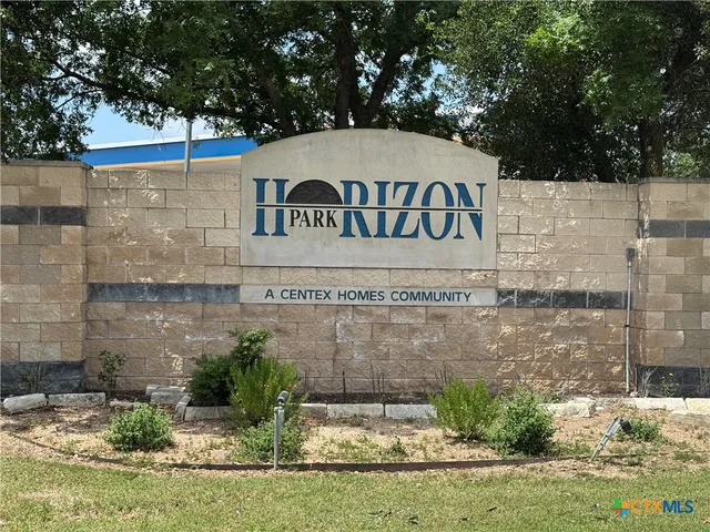 a view of a park with large trees