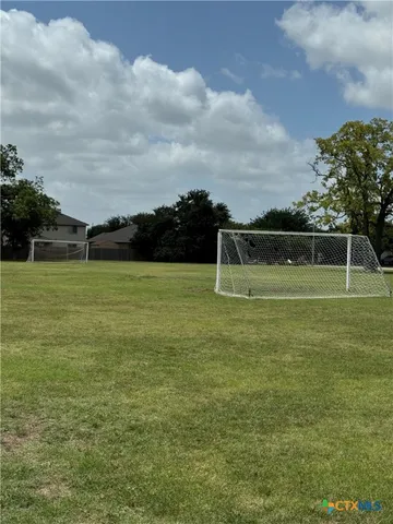 a view of a swimming pool with a yard