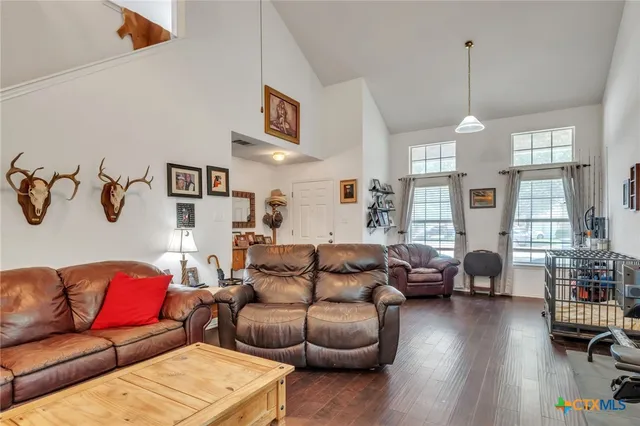 a living room with furniture and a chandelier