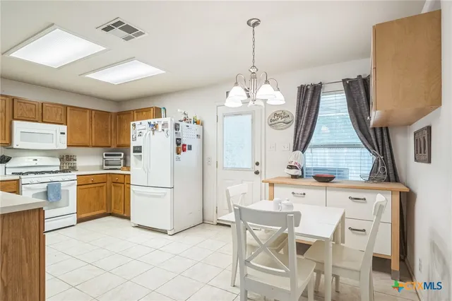 a kitchen with refrigerator and cabinets