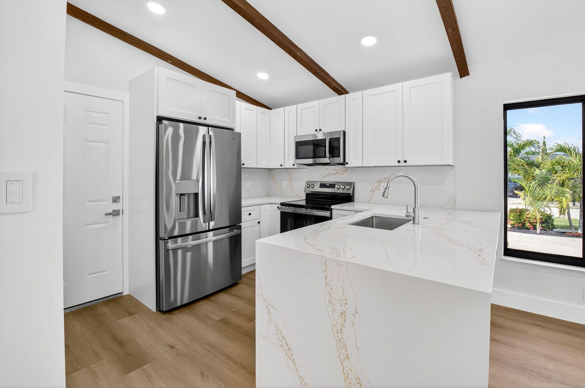 10151 Windtree Lane Boca Raton, FL 33428 - Photo 12 of 39 a kitchen with stainless steel appliances a refrigerator sink and microwave