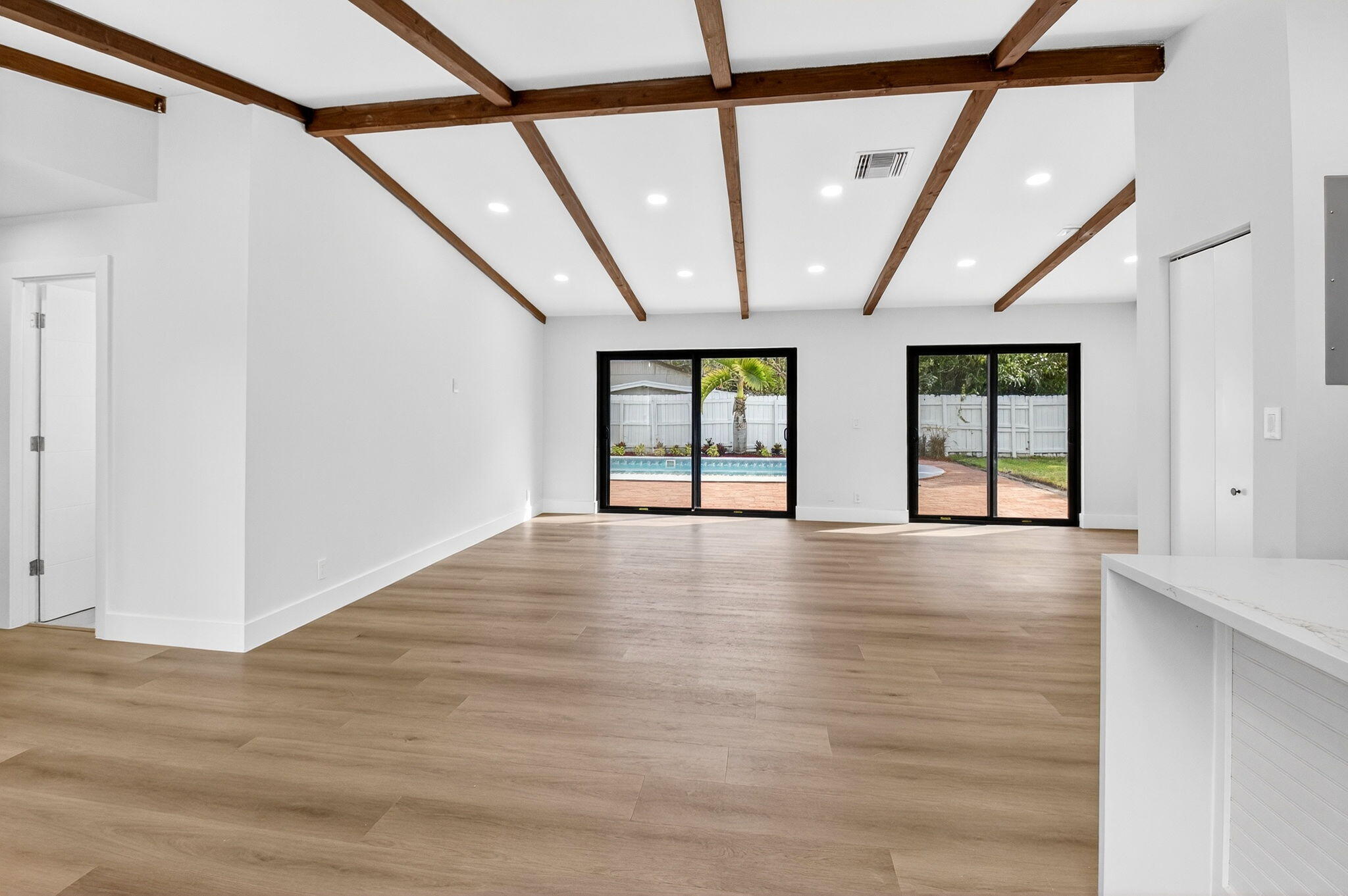 10151 Windtree Lane Boca Raton, FL 33428 - Photo 14 of 39 a view of an empty room with wooden floor and windows
