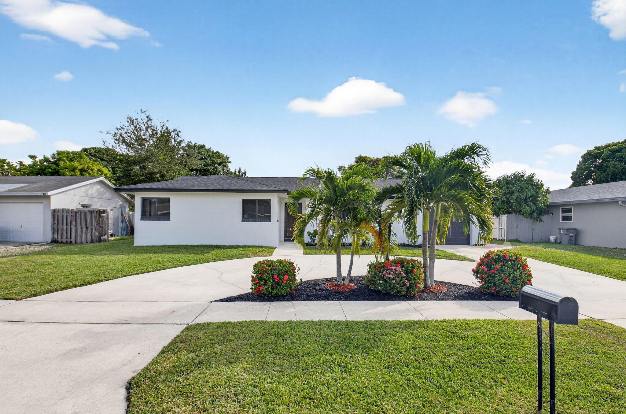 10151 Windtree Lane Boca Raton, FL 33428 - Photo 2 of 39 a front view of house with yard and outdoor seating