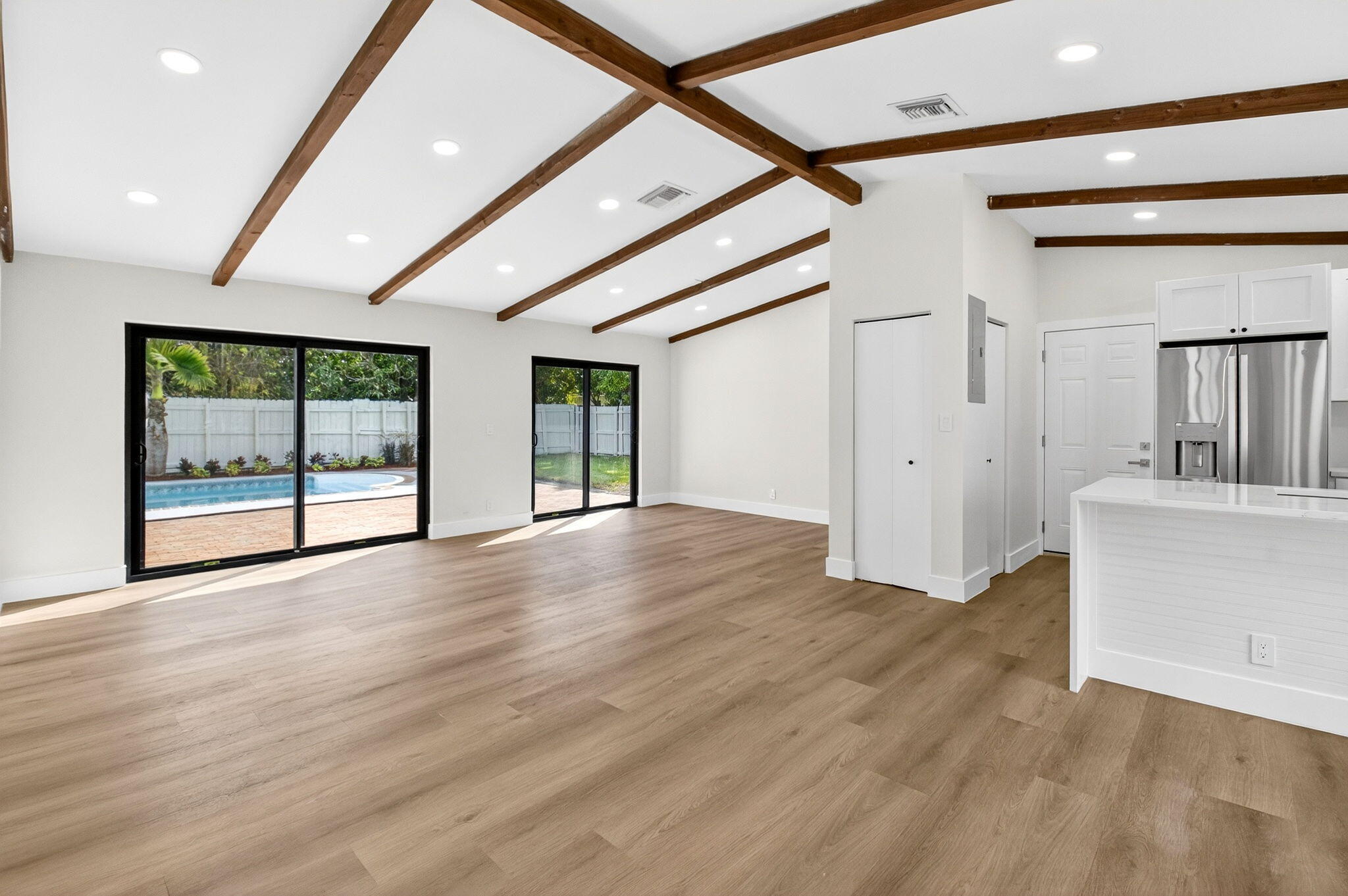 10151 Windtree Lane Boca Raton, FL 33428 - Photo 7 of 39 a view of an empty room with wooden floor and a window