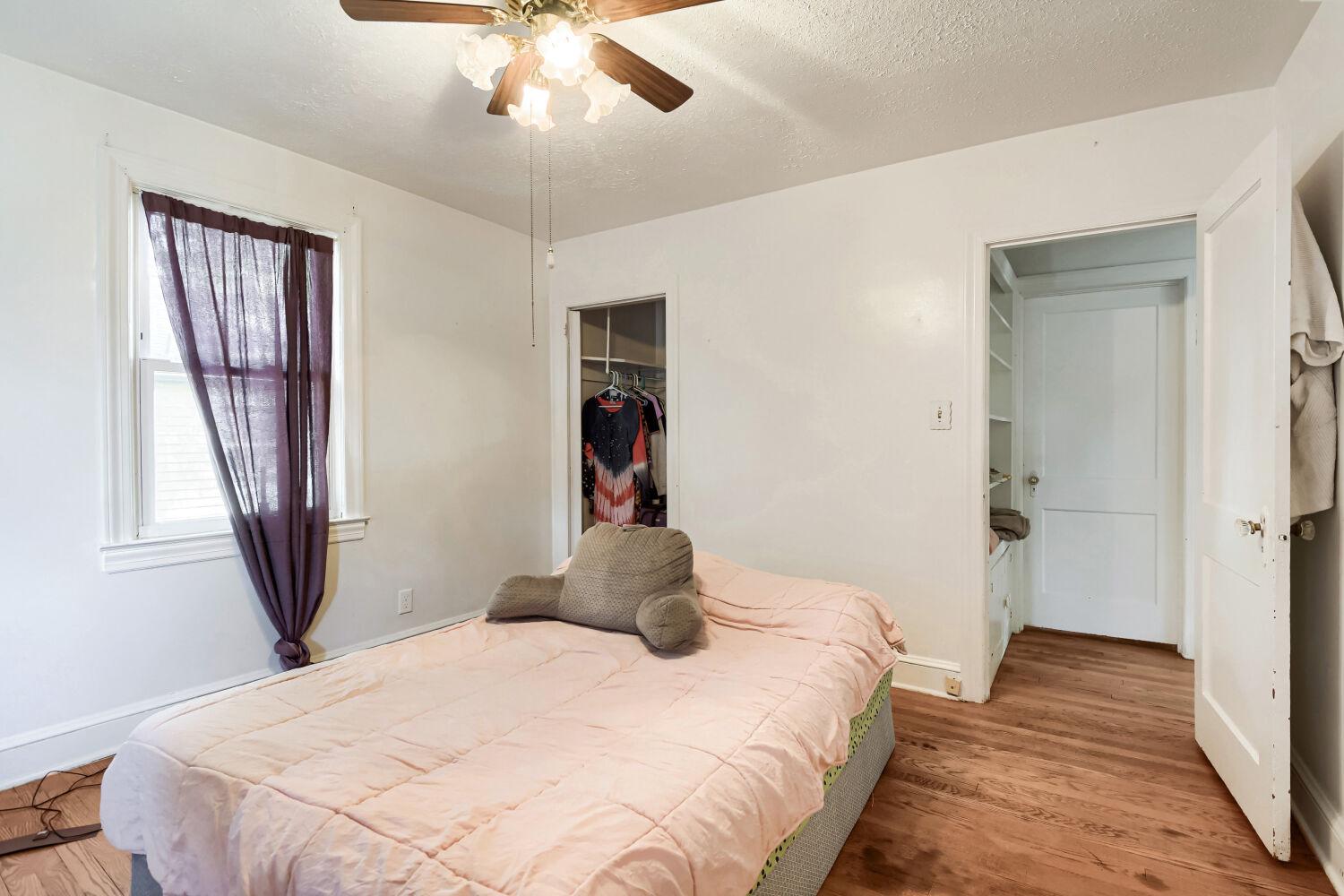 217 Doris Avenue Baltimore, MD 21225 - Photo 7 of 16 a bedroom with a bed and a chandelier