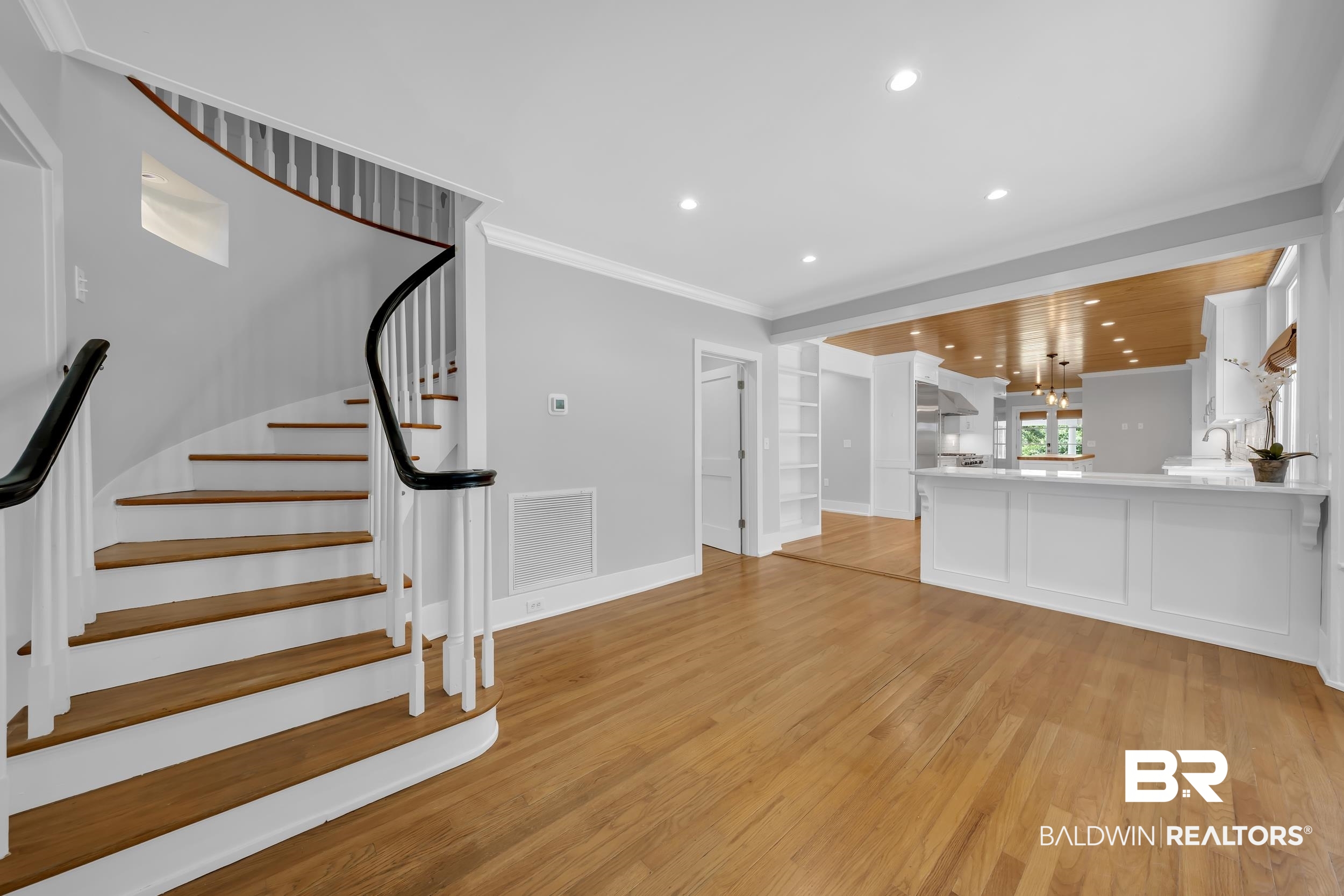43199 Pine Grove Road Bay Minette, AL 36507 - Photo 33 of 71 Curved staircase with wood-finish treads and black handrails