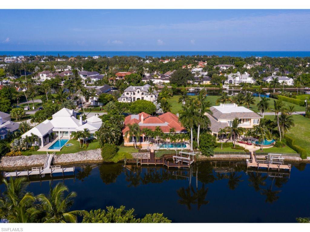 3275 Gin Lane Naples, FL 34102 - Photo 1 of 13 an aerial view of residential houses with outdoor space and swimming pool